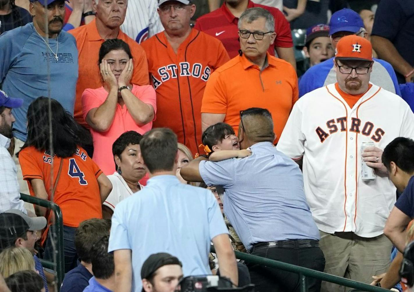 A young child is carried from the stands after being injured by a foul ball off the bat of Chicago Cubs' Albert Almora Jr. during the fourth inning of a baseball game against the Houston Astros Wednesday, May 29, 2019, in Houston.