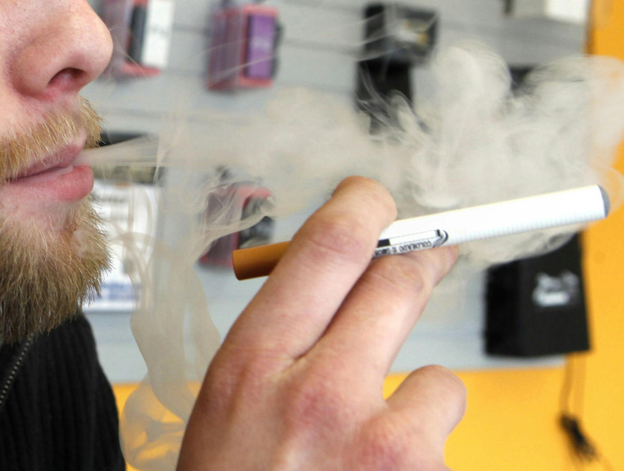 FILE - A sales associate demonstrates the use of a electronic cigarette and the smoke like vapor that comes from it in Aurora, Colo. on Wednesday, March 2, 2011. Children - like adults - are increasingly trying electronic cigarettes, according to the first large national study to gauge use by middle and high school students. About 2 percent of the students said they‚Äôd used an e-cigarette in the previous month, according to a survey done in 2012. That was up from 1 percent in 2