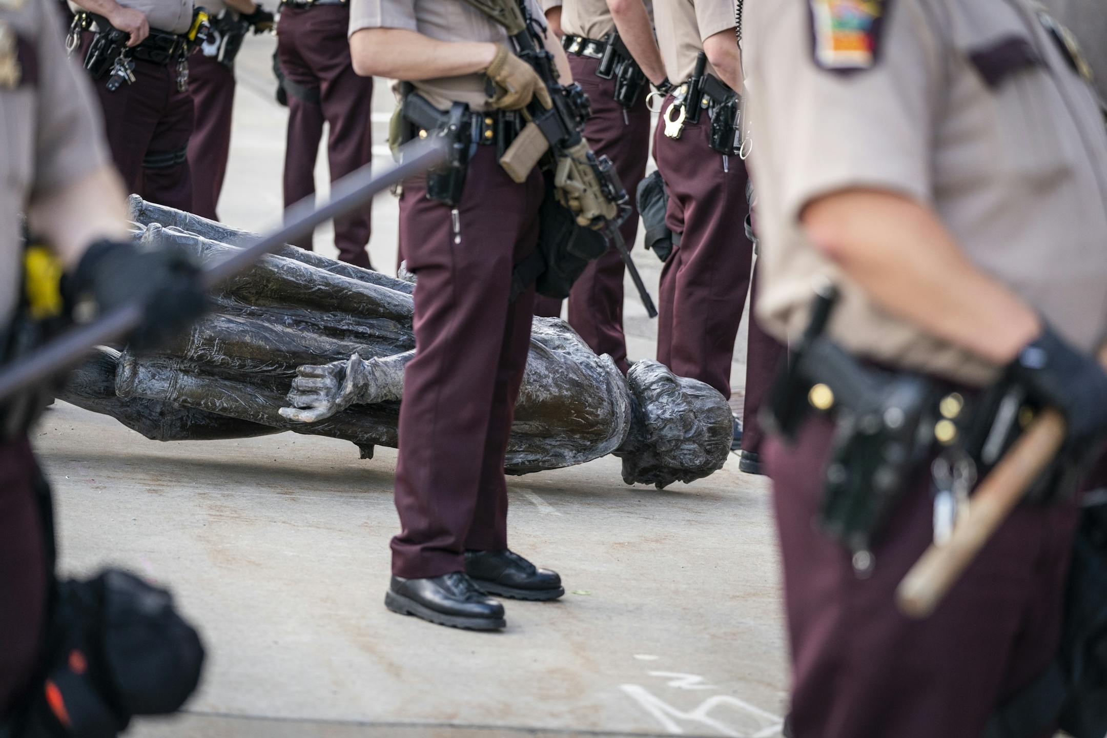 Minnesota State Troopers surrounded the statue after it was toppled, until it could be taken away by a tow truck.
