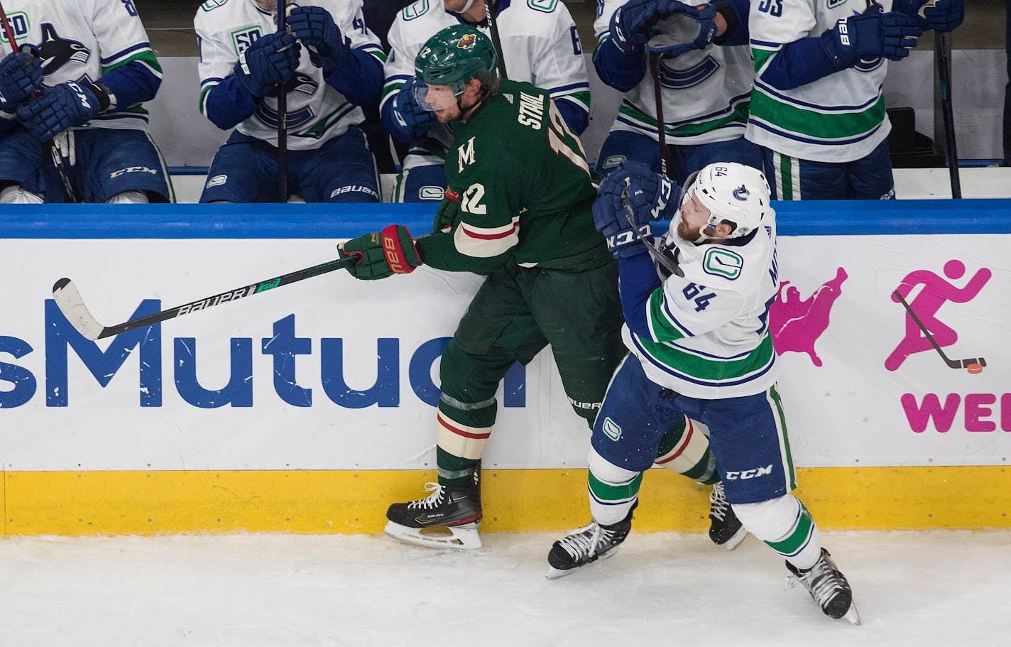 The Wild's Eric Staal is checked by Vancouver's Tyler Motte during the first period Friday night.