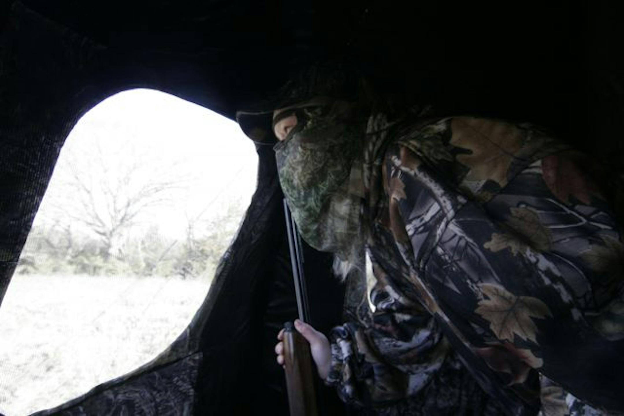 Lorna Wright, 13, peered out the window of her blind on the alert for a tom. She was among more than 300 youths who hunted turkeys for the first time last weekend.
