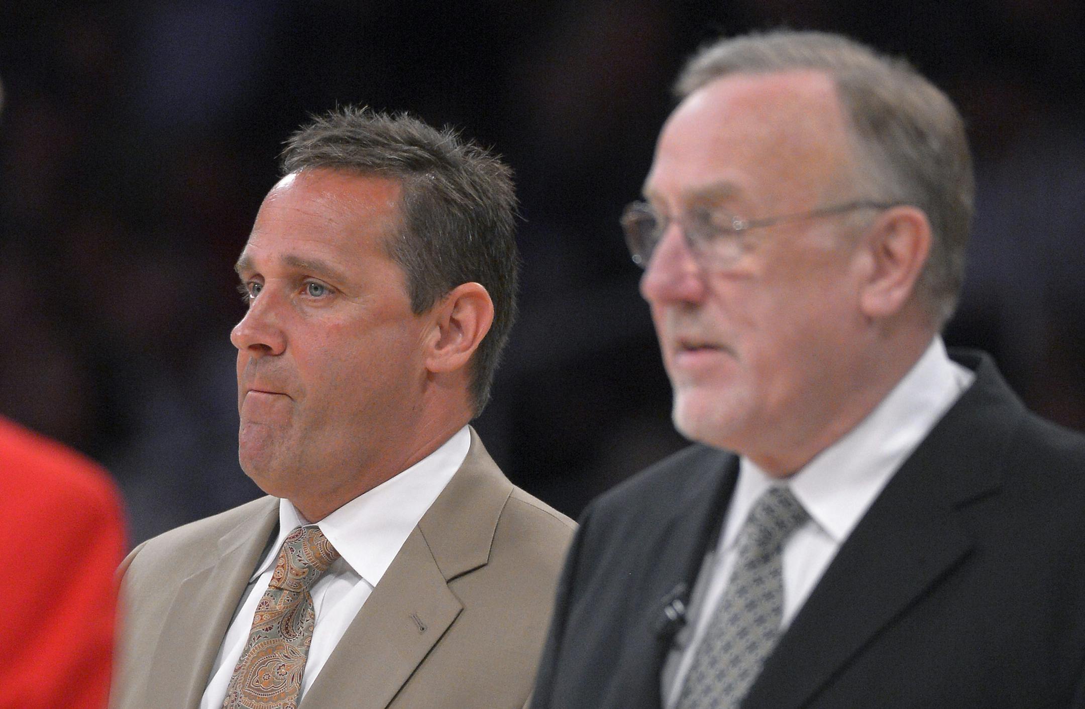 In this Feb. 28, 2013 photo, Minnesota Timberwolves assistant coach Bill Bayno, left, looks on along with head coach Rick Adelman during the first half of their NBA basketball game against the Los Angeles Lakers in Los Angeles. Now an assistant with the Minnesota Timberwolves, Bayno has been sober for nearly 11 years. He had to go through the CBA, ABA and the Philippines to re-establish himself in the hoops community, and he's spent that time also searching for a little more balance in a life th