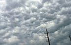 Clouds amass over power lines following days of storms on Sunday, May 5, 2024, in Humble, Texas. (Elizabeth Conley/Houston Chronicle via AP)