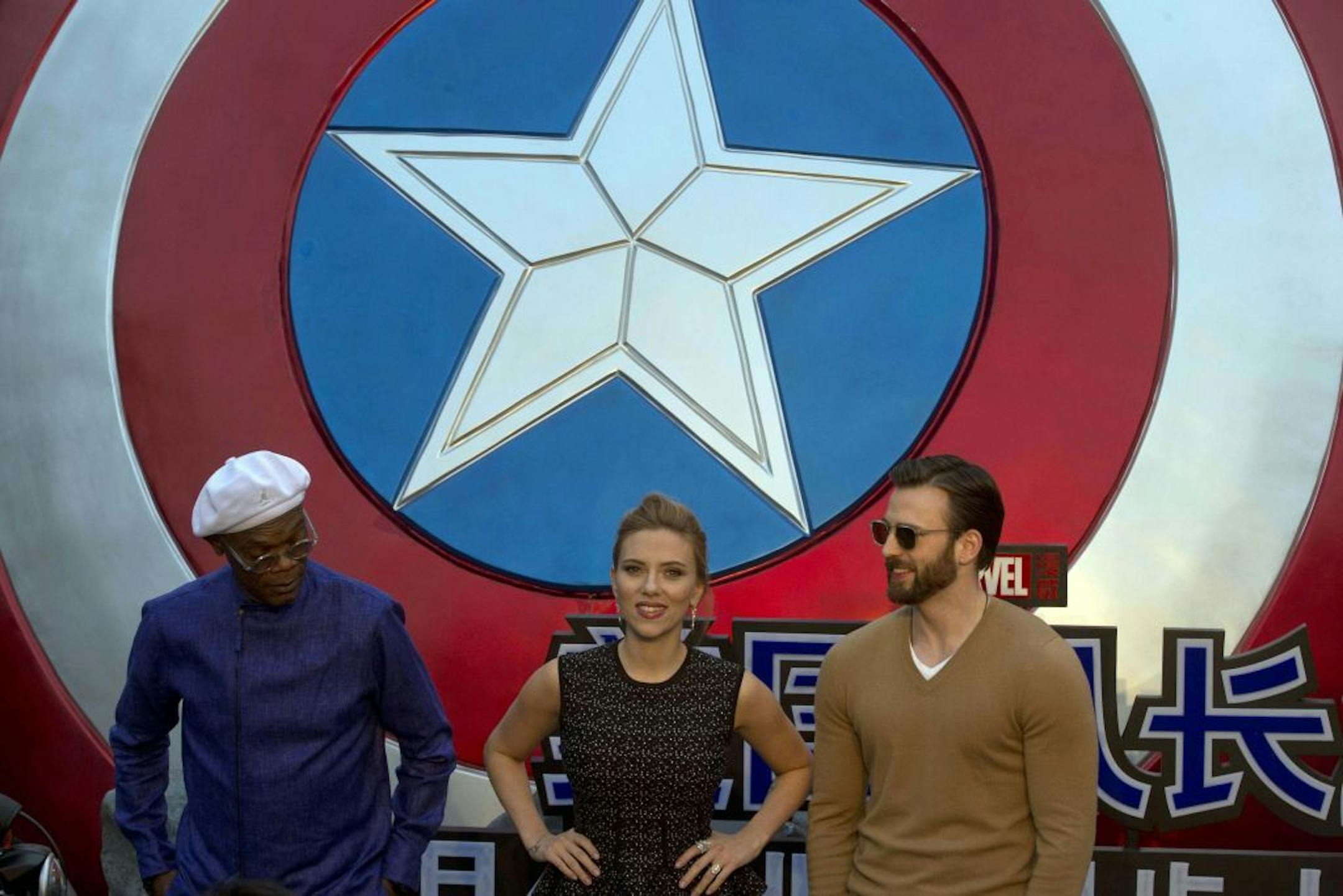 Scarlett Johansson, center, stands with Samuel L. Jackson, left, and Chris Evans during a publicity event ahead of the April release of the movie "Captain America: The Winter Soldier" in Beijing, China, Monday, March 24, 2014.