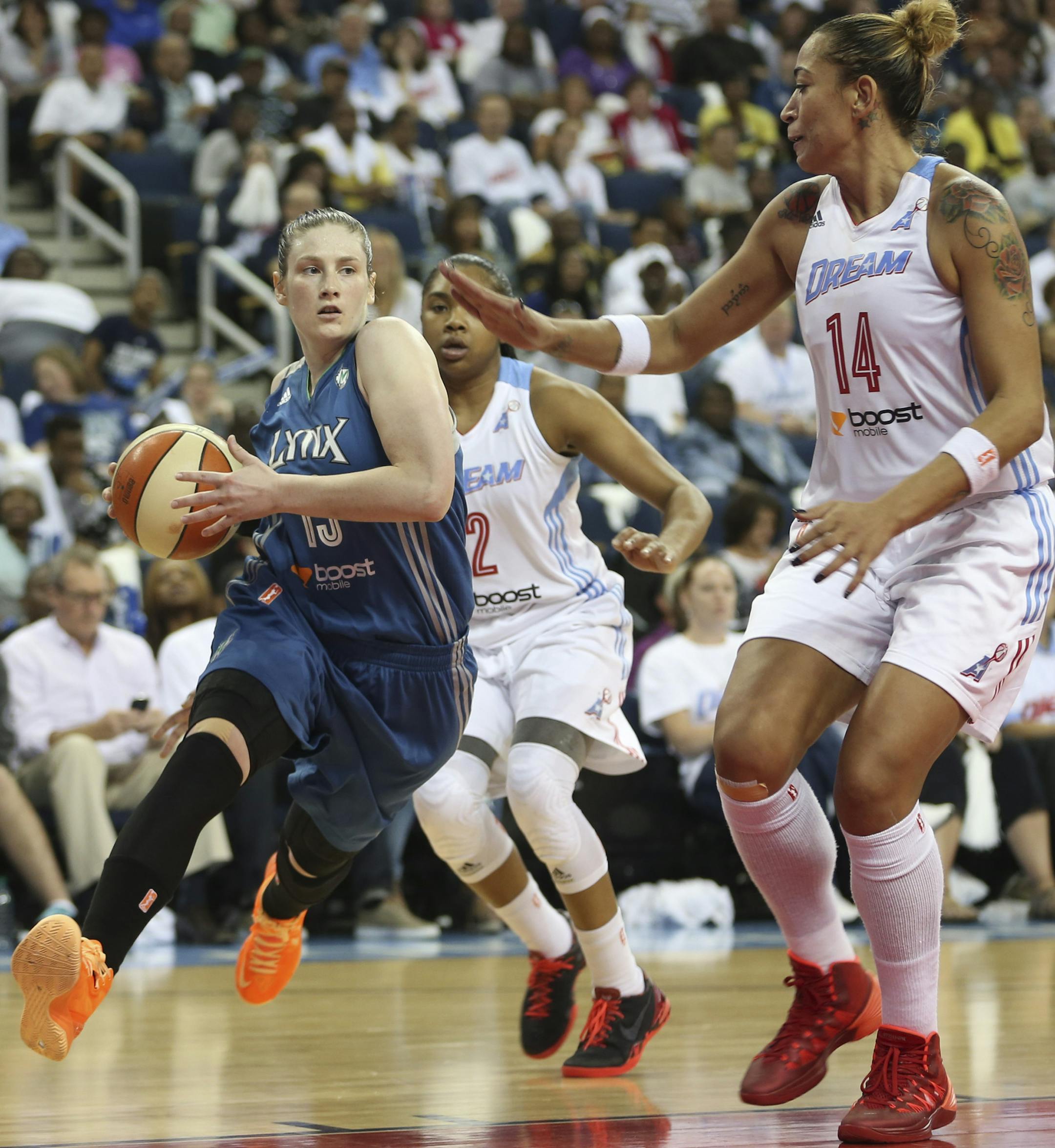 Lindsay Whalen #13 of the Minnesota Lynx charges toward the basket ahead of the Atlanta Dream's Armintie Herrington #22 and Erika de Souza #14 during the first half of Game 3 of the WNBA finals on Thursday, October 10, 2013, at the Gwinnett Center in Duluth, Ga. ] RENEE JONES SCHNEIDER ‚Ä¢ reneejones@startribune.com