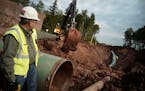 Workers installing Enbridge's Line 3 replacement pipeline in Wisconsin. Regulators are still reviewing whether to allow the construction in Minnesota.