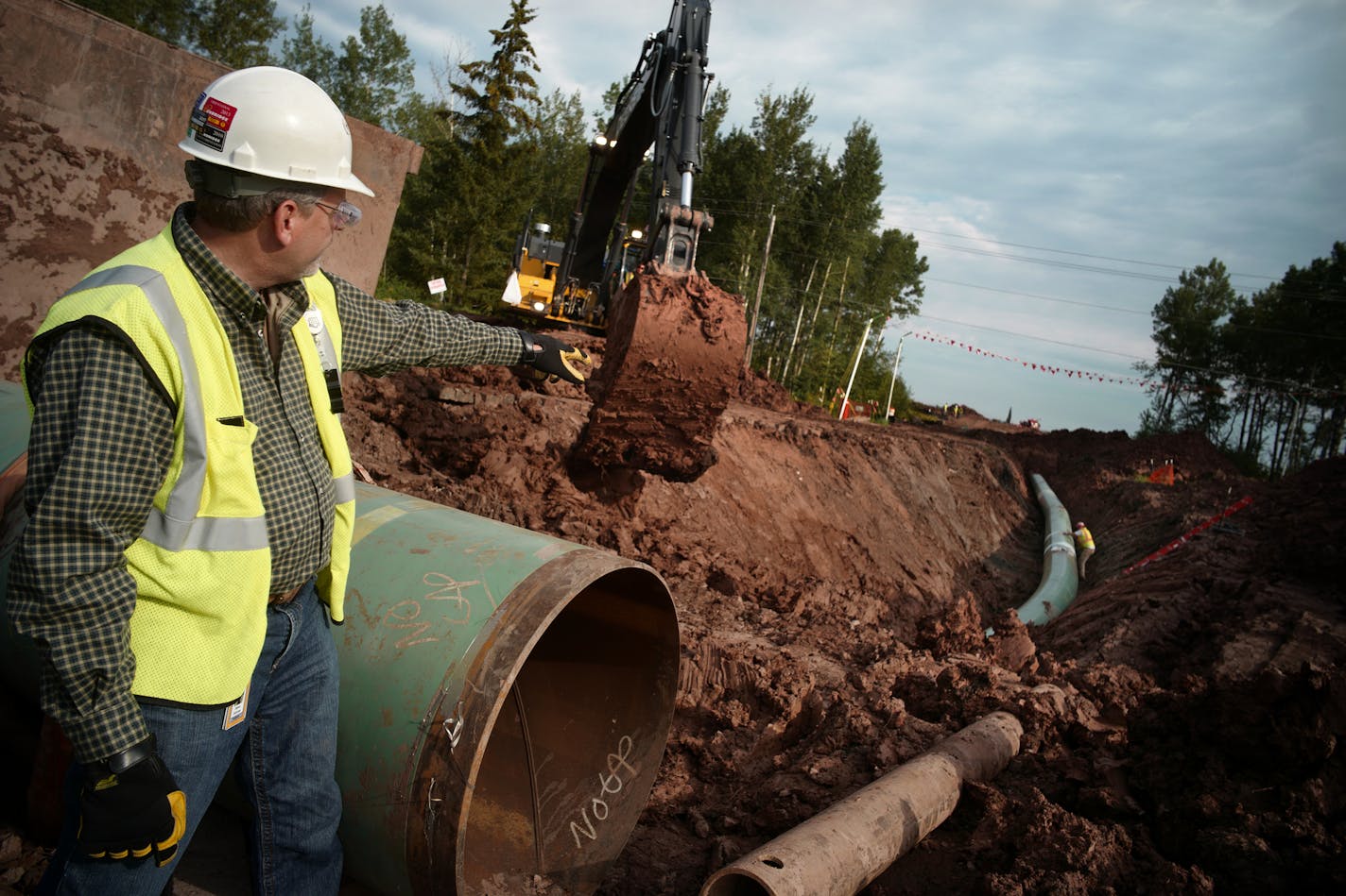 Workers installing Enbridge's Line 3 replacement pipeline in Wisconsin. Regulators are still reviewing whether to allow the construction in Minnesota. (RICHARD TSONG-TAATARII/Star Tribune file photo)