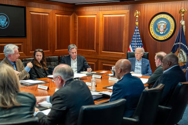 In this image released by the White House, President Joe Biden, third from right, meets with members of the National Security team regarding the unfol