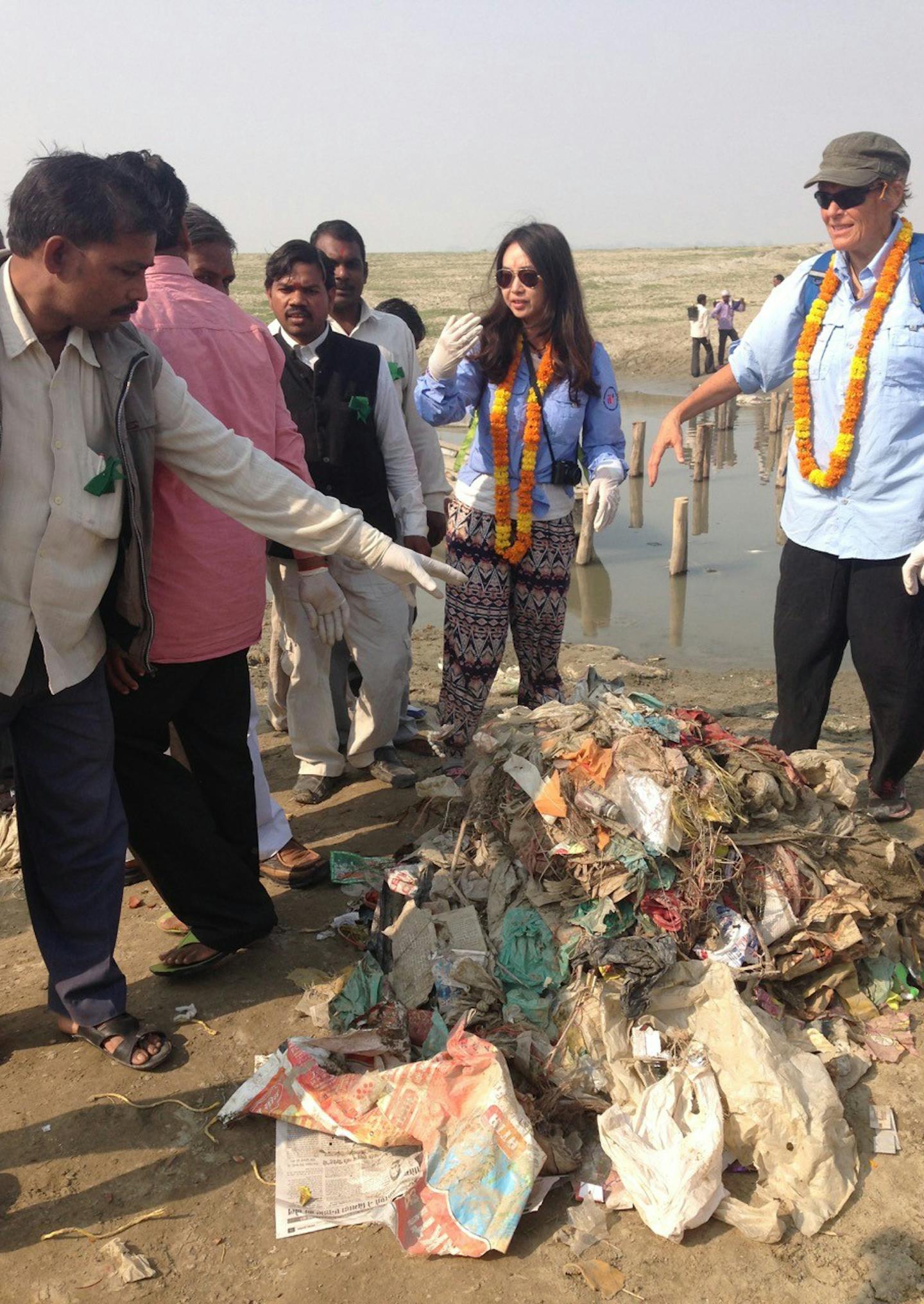 Expedition team members Cindy Jiaojiao, center, and Liv Arnesen collected trash with villagers.