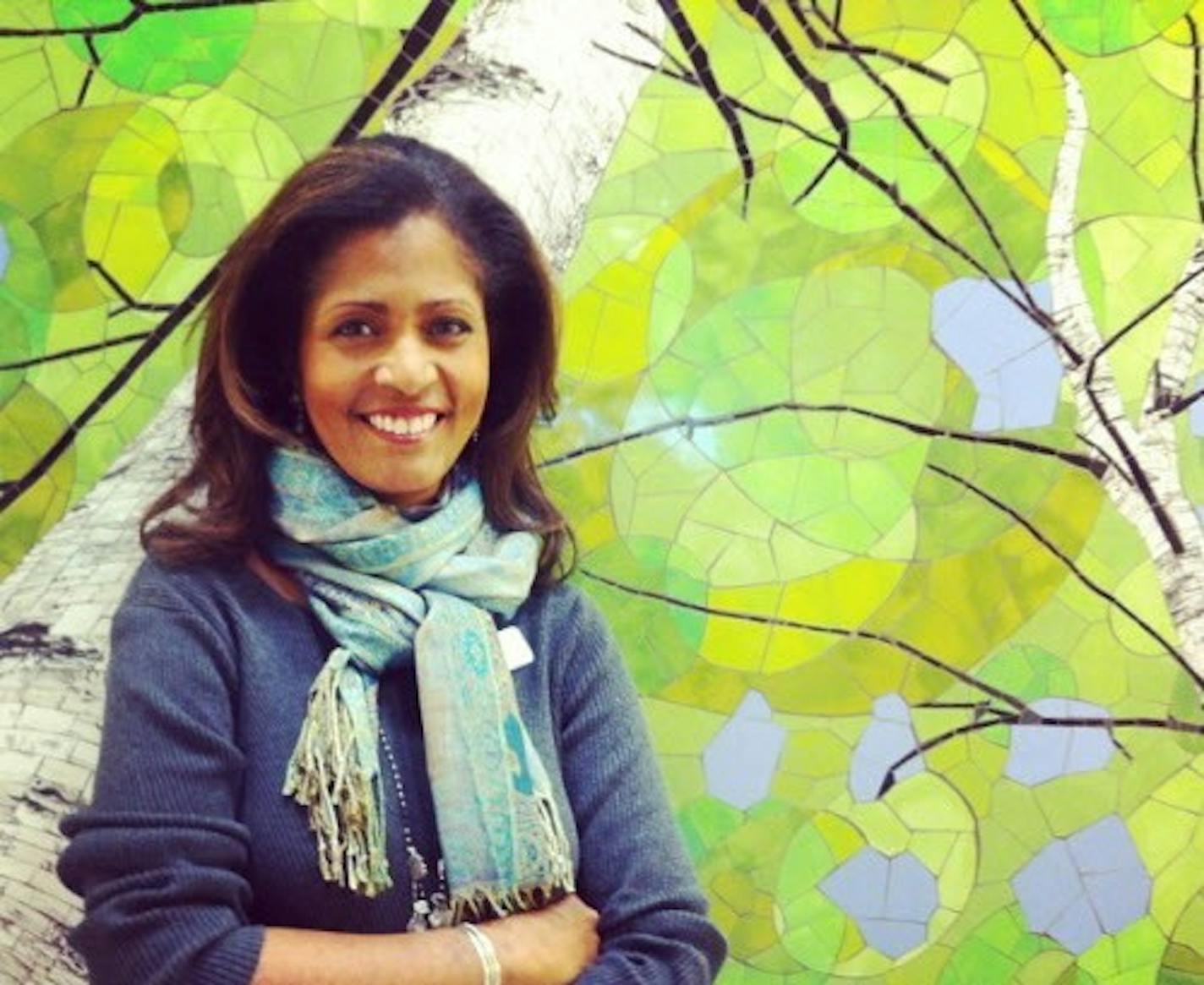 Robyne Robinson stands in front of a birch-tree mural by Minnesota artist Barbara Keith in one of the newly renovated bathrooms at the airport.