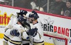 Chanhassen players congratulate relief goalie Grant Atterson at the end of  the third period.