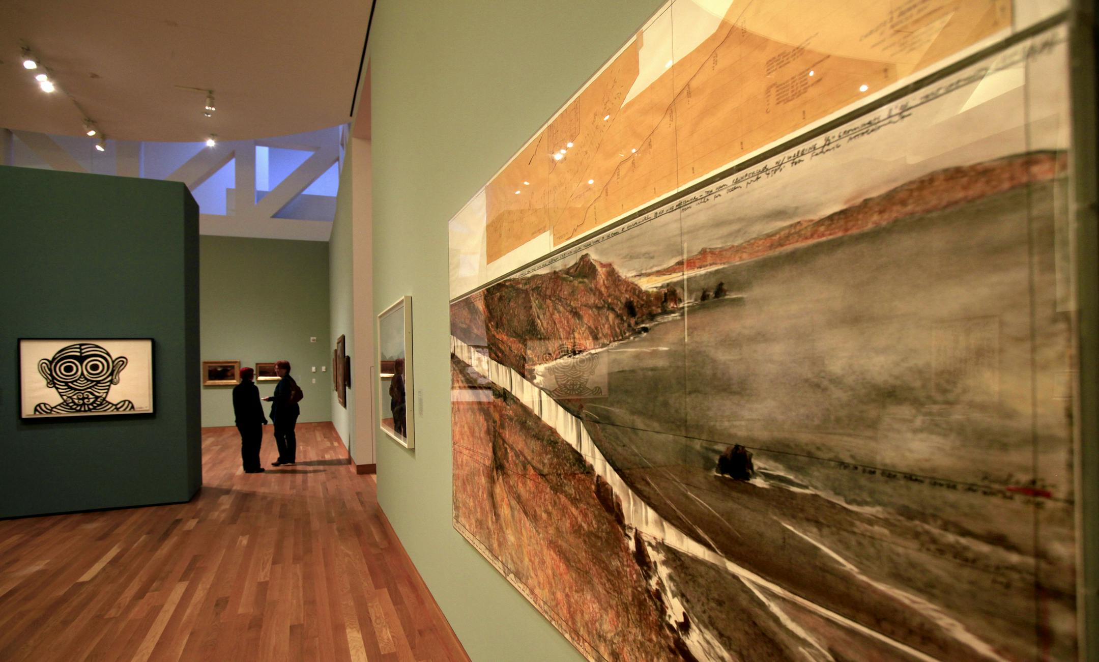 Ilana Green from Chicago, IL discusses the art with Roberta Jaffe of Minneapolis. Mn Museum of American Art's collection at the Weisman Art Museum, 333 E. River Rd., Mpls, MN on February 6, 2013. Art from Left to right: Scarfication, 1967 by Alexander Calder. Far wall, Stalking Deer, 1860 by Jasper Cropsey. Sunset and Moon, 1873 by Joseph Rusling Meeker. Right wall closest at on frame: Runnign Fence: Project for Sonoma and Marin Counties, California, 1976 by Christo. ] JOELKOYAMA‚Ä&#