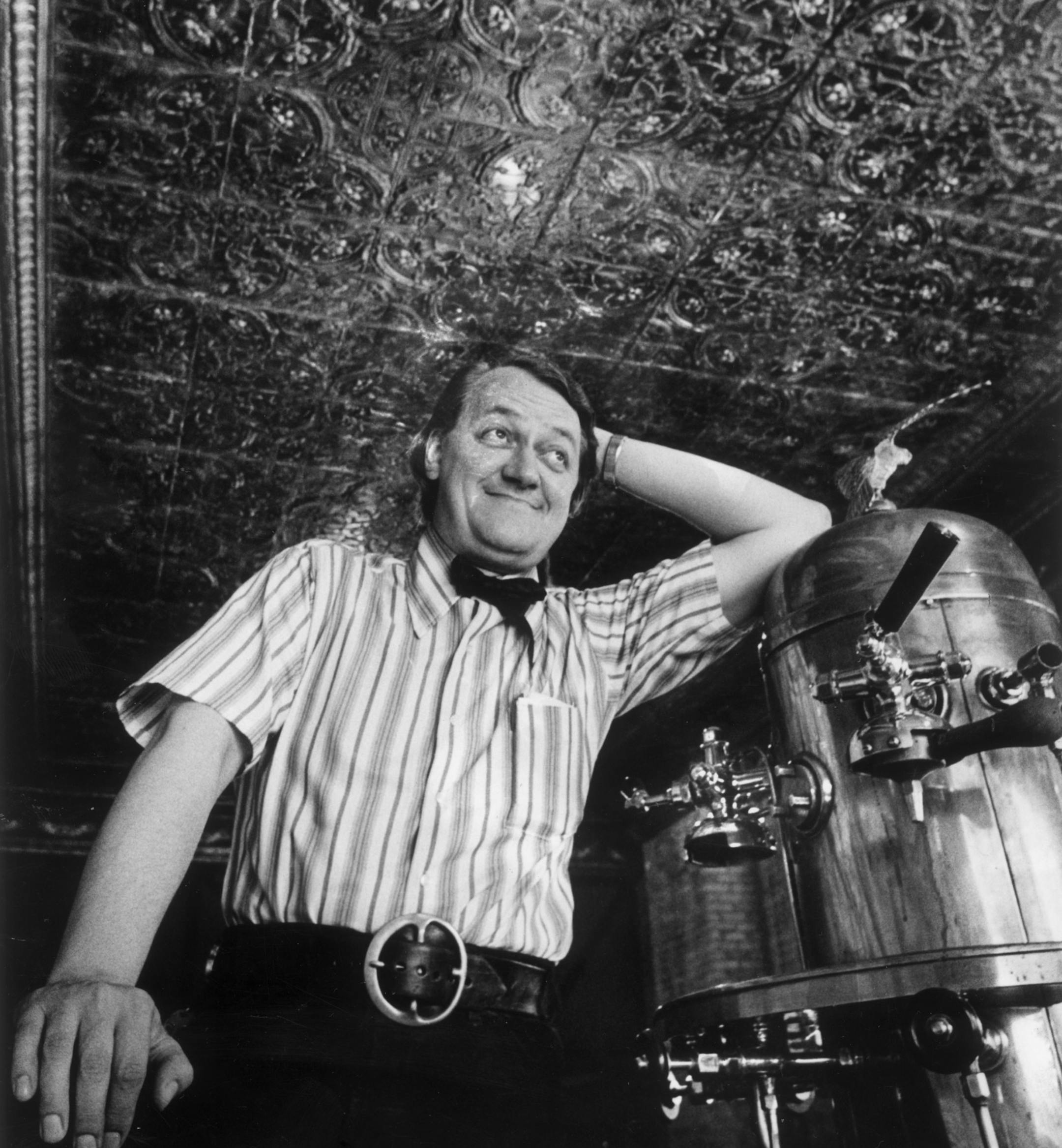 Dudley Riggs and espresso machine beneath his turn of the century West Bank ceiling. August 1971 photo by Minneapolis Tribune staff photographer Earl Seubert.