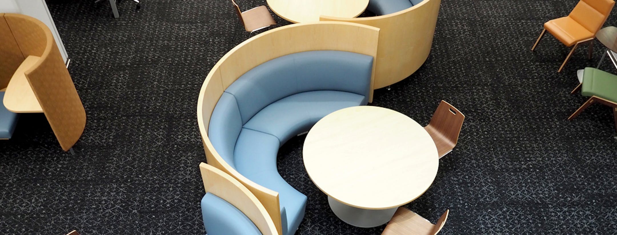 Furniture, upholstered in warm, inviting colors, often mimics Rapson's famous midcentury designs; a variation on his distinctive rocker will appear this spring on the library's sheltered patio. Even the lollipop light fixtures — icons from Rapson's Guthrie lobby — were salvaged, repaired and reinstalled.