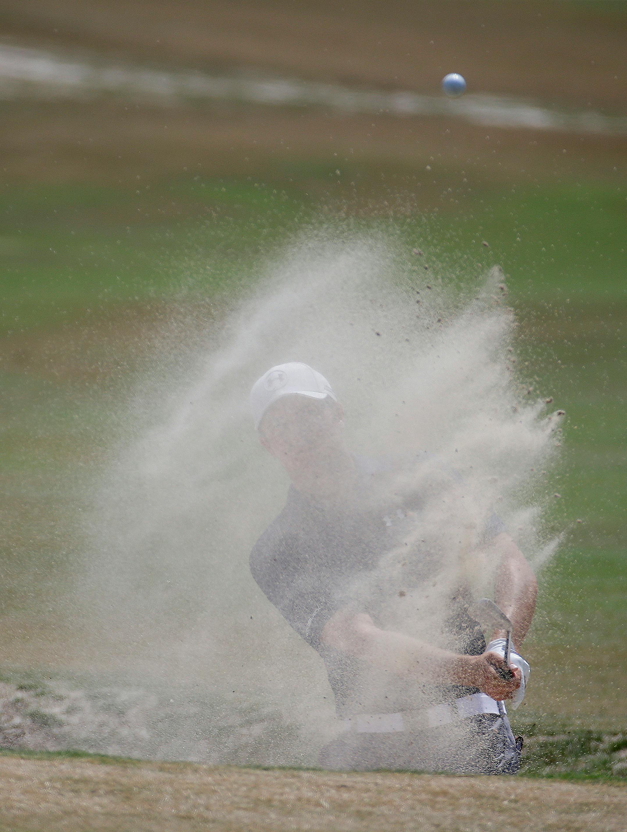Jordan Spieth hits out of the bunker on the fourth hole during the third round of the U.S. Open golf tournament in Pinehurst, N.C., Saturday, June 14, 2014.