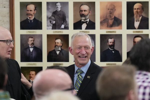 Roger Reinert stood in front of some of the forty Duluth mayors who came before him after adressing the crowd at his swearing in ceremony Tuesday, Jan