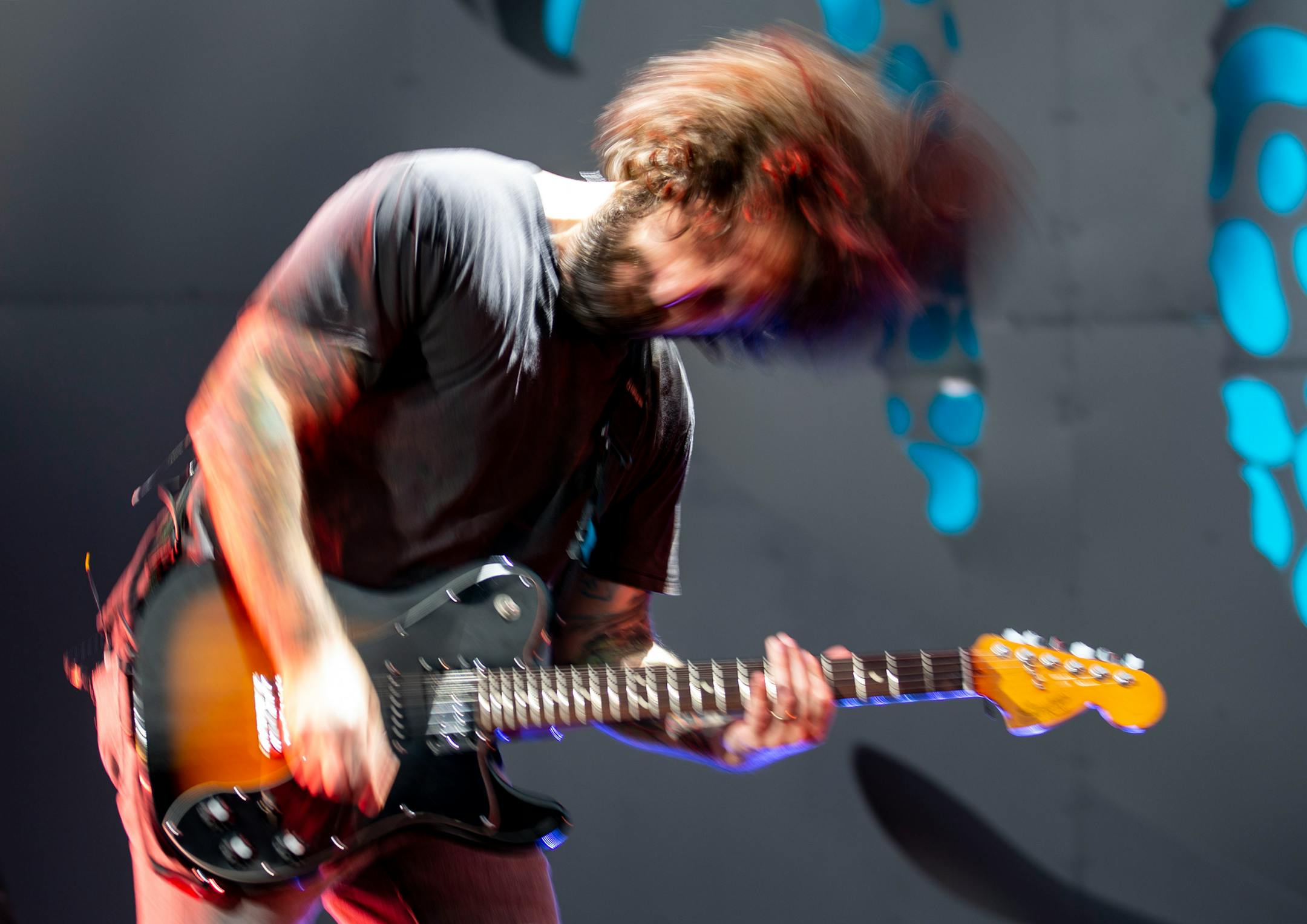 Joe Trohman, guitarist for Fall Out Boy, threw his hair back and forth during the band's opening song at the Hella Mega Tour at Target Field in Minneapolis on Monday.