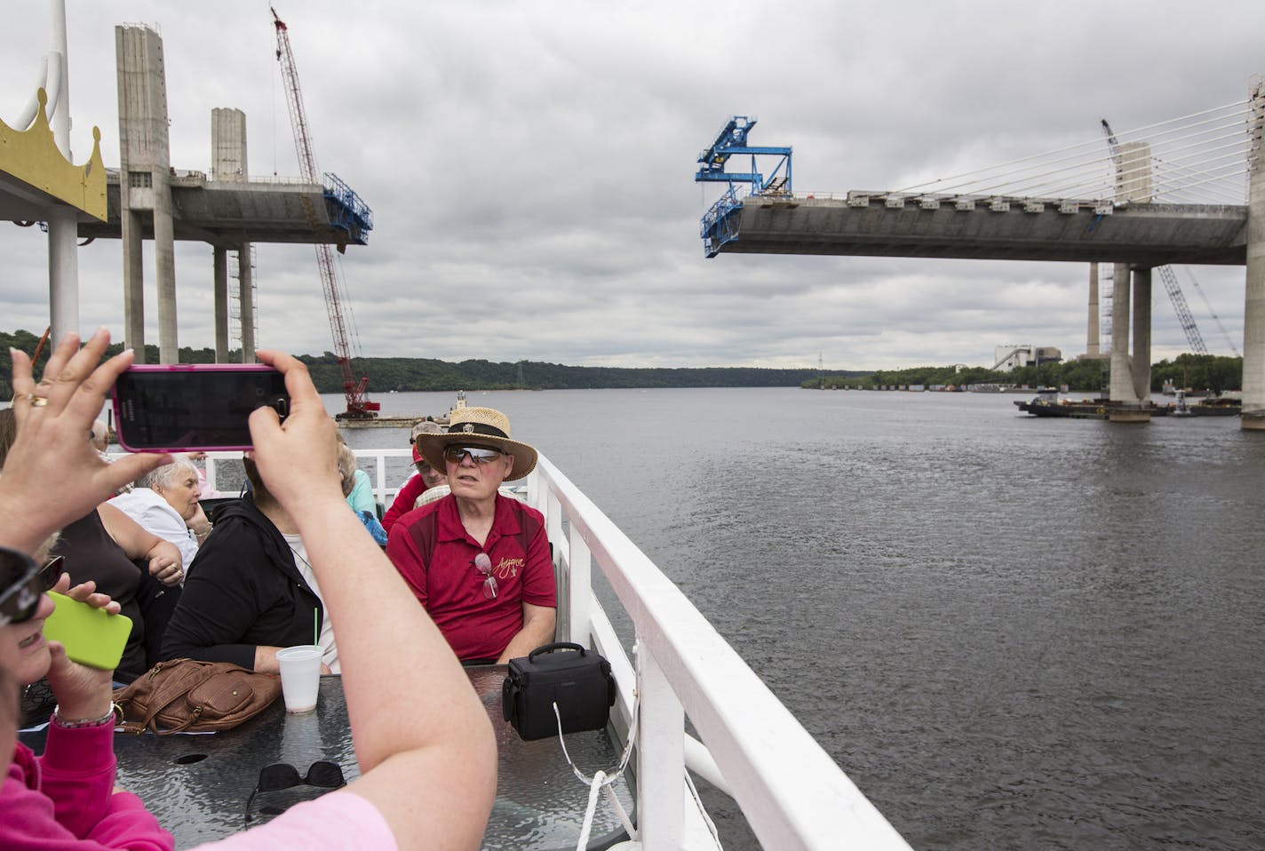 Passengers get photos of the bridge construction. ] (Leila Navidi/Star Tribune) leila.navidi@startribune.com BACKGROUND INFORMATION: A boat tour is part of the MnDOT public relations campaign for the St. Croix Crossing bridge project. The sold out tour boat, run by St. Croix Boat and Packet, left from Stillwater on Wednesday, June 15, 2016.