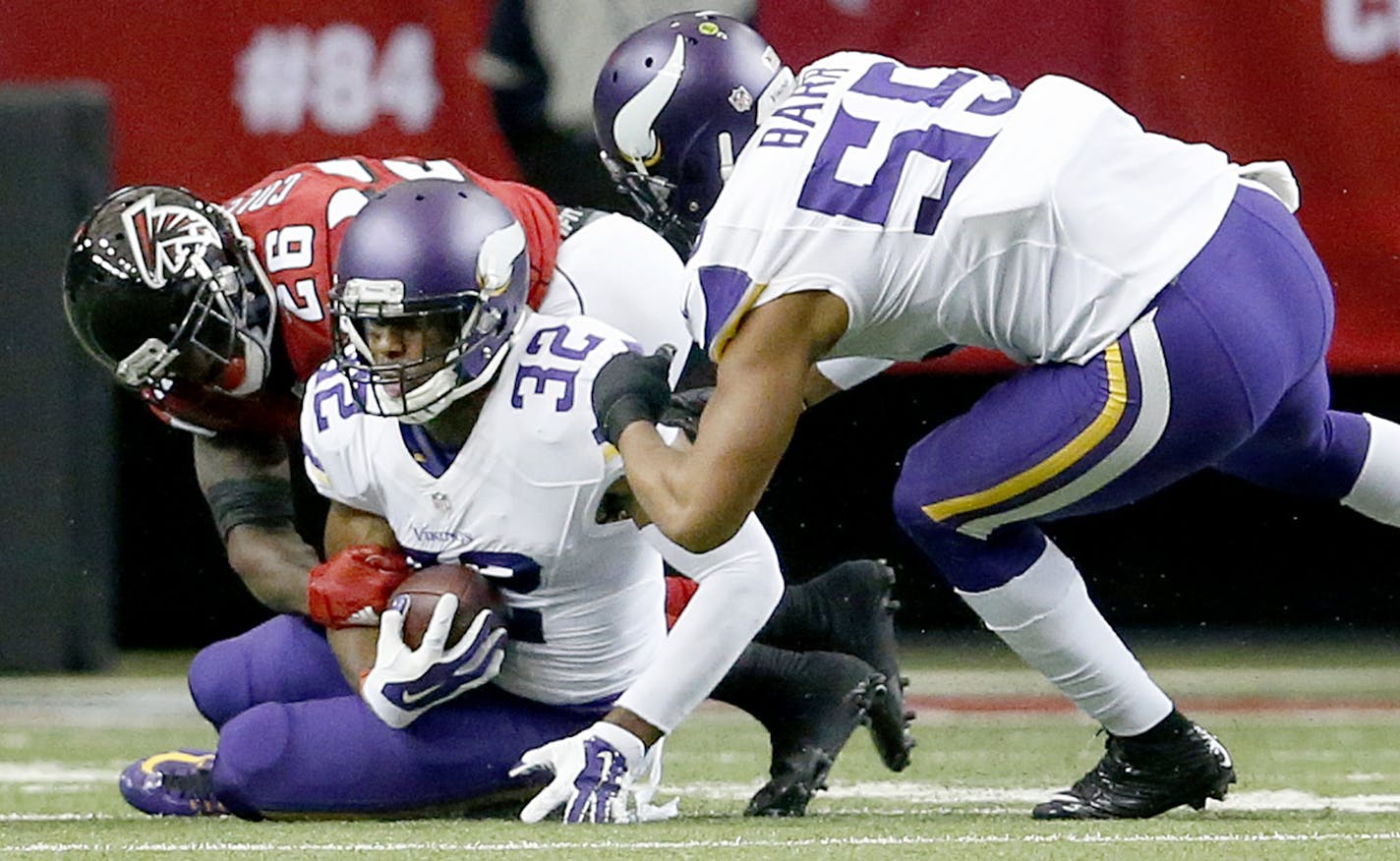 Vikings safety Antone Exum Jr. (32) recovered a fumble by Falcons running back Tevin Coleman (26) that was forced by linebacker Anthony Barr (55) in the first quarter.