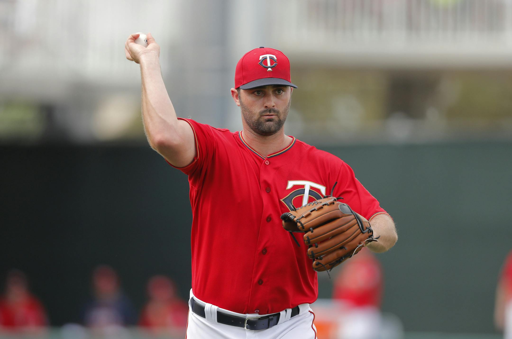 Minnesota Twins relief pitcher Matt Magill throuws out Pittsburgh Pirates JB Shuck on a grounder on the 4th inning of their spring training baseball game in Fort Myers, Fla., Tuesday, Feb. 26, 2019. (AP Photo/Gerald Herbert)