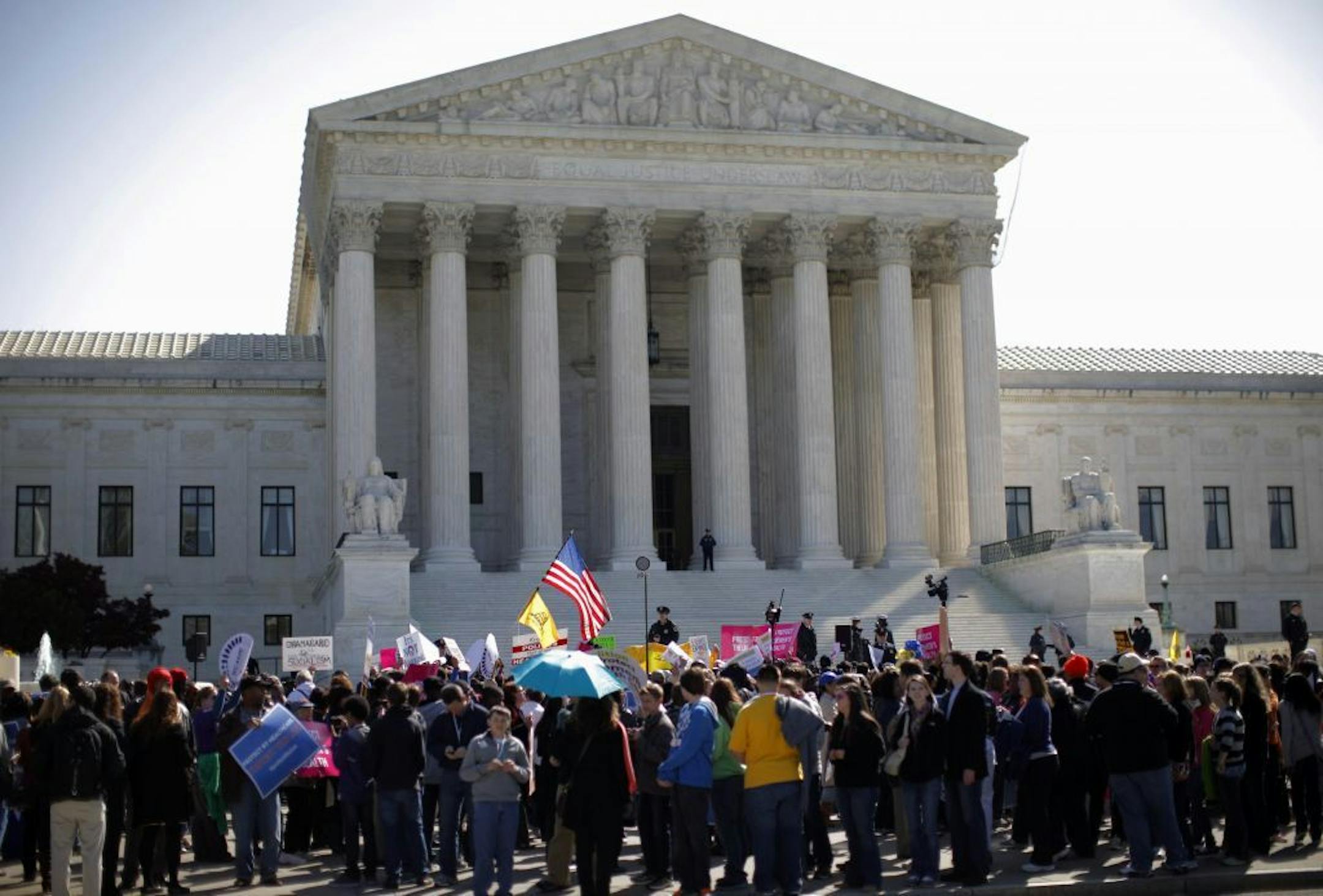 Supporters and opponents of health care reform rally in front of the Supreme Court in Washington, Tuesday, March 27, 2012,