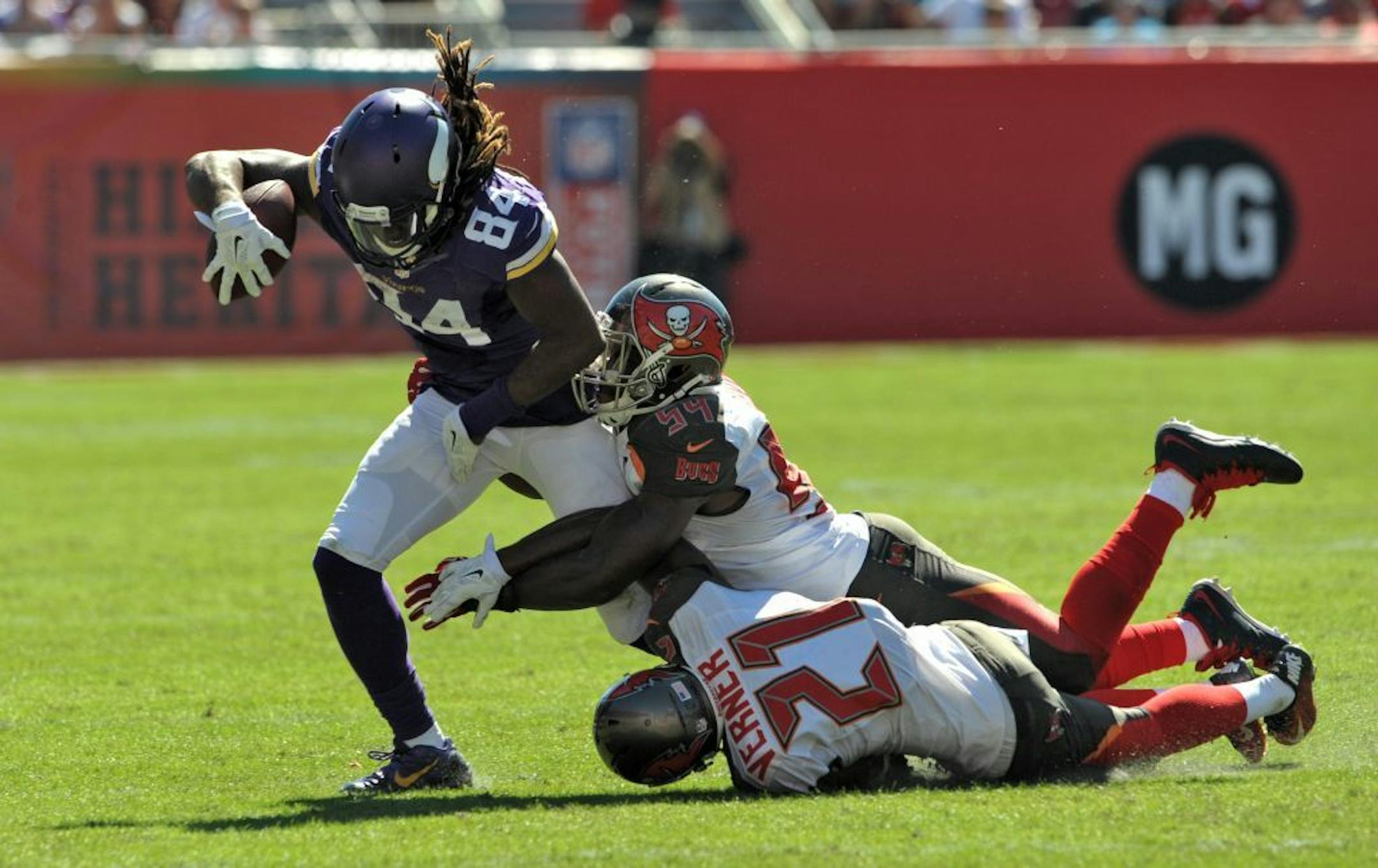 Minnesota Vikings wide receiver Cordarrelle Patterson (84) is stopped by Tampa Bay Buccaneers outside linebacker Lavonte David (54) and cornerback Alterraun Verner (21) during the second quarter of an NFL football game Sunday, Oct. 26, 2014 in Tampa, Fla.