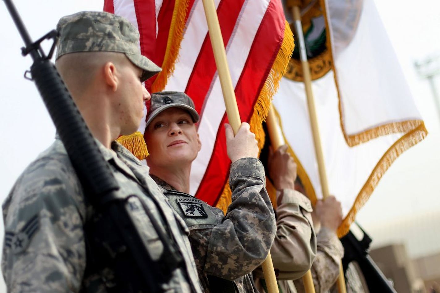 BAGHDAD, IRAQ - DECEMBER 15: U.S. military personnel carry flags before a casing ceremony where the United States Forces- Iraq flag was retired, signifying the departure of United States troops from Iraq, at the former Sather Air Base on December 15, 2011 in Baghdad, Iraq. United States forces are scheduled to entirely depart Iraq by December 31, there are currently around 4,000 troops remaining in Iraq.