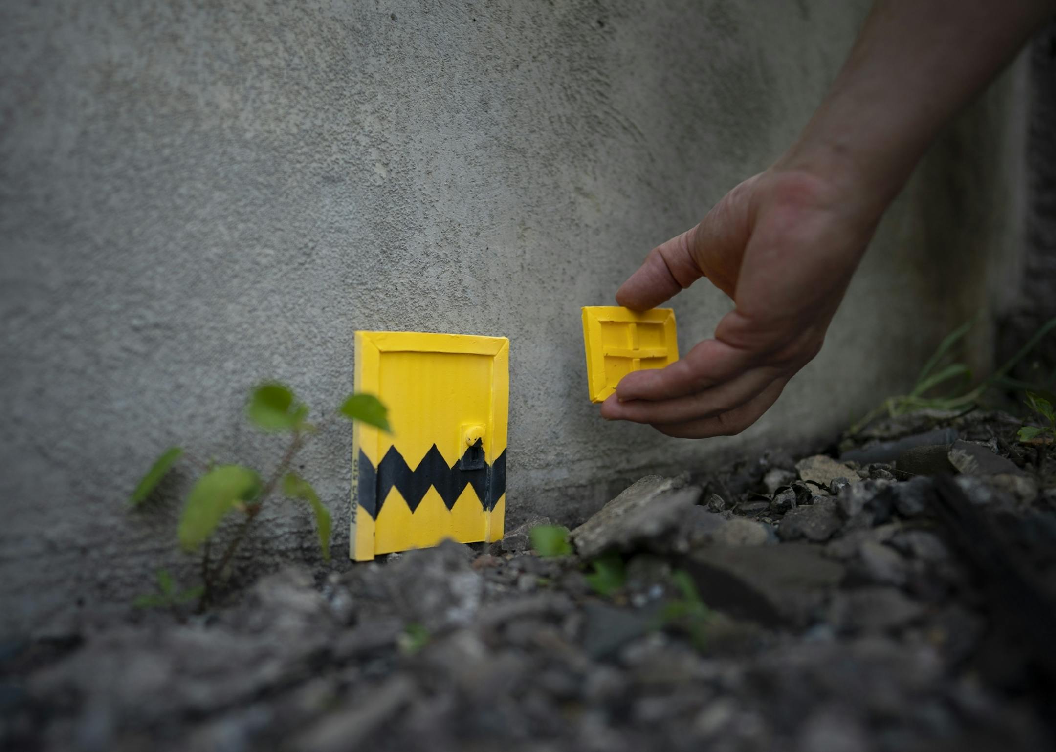 Mous510 installed one of his mouse doors - with a Peanuts theme - on a bridge abutment.