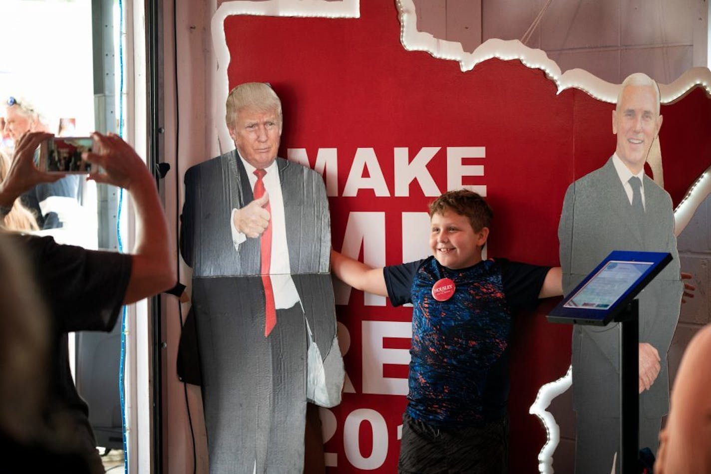 Anthony Rossini, 10, wanted to have his photo taken with cutouts of President Donald Trump and Vice President Mike Pence at the Republican booth at the Minnesota State Fair.