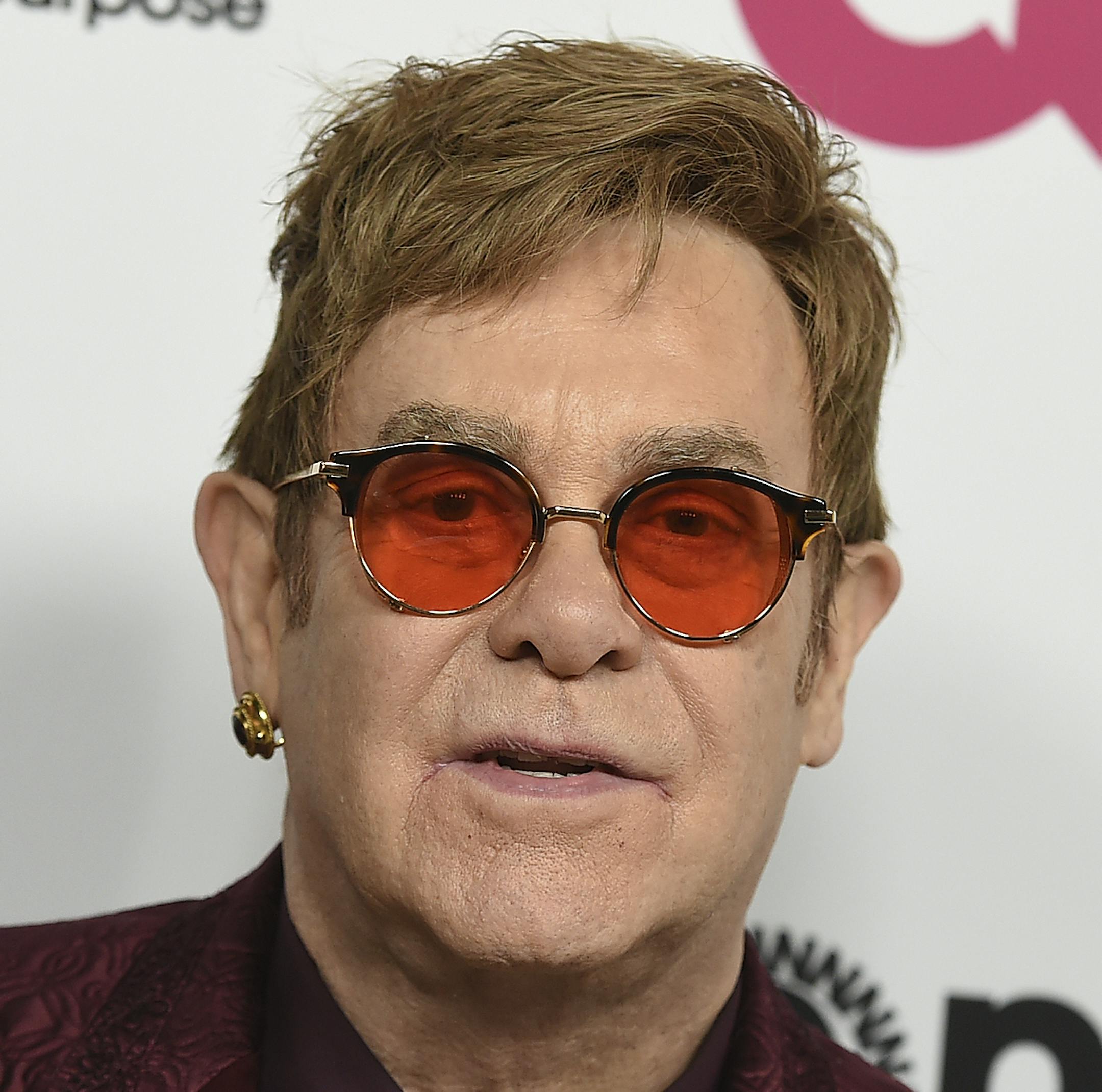 FILE - In this March 25, 2017 file photo, Elton John arrives at Elton John's 70th Birthday and 50-Year Songwriting Partnership with Bernie Taupin celebration in Los Angeles. Elton John has cancelled more than a month of upcoming shows after contracting an “unusual” bacterial infection during a South America tour that left him in intensive care for two nights. The 70-year-old performer is expected to make a full recovery and hopes to return to a stage in Twickenham, England on June