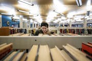 Halle Martin, 22, a student at Concordia University looked for a book at the Rondo library on Monday afternoon. ] CARLOS GONZALEZ &#x2022; cgonzalez@s