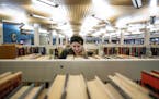 Halle Martin, 22, a student at Concordia University looked for a book at the Rondo library on Monday afternoon. ] CARLOS GONZALEZ &#x2022; cgonzalez@s