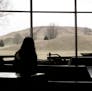 **FILE** Visitors to the Cahokia Mounds State Historic Site and Interpretive Center in Collinsville, Ill., look through the window at Monks Mound, con