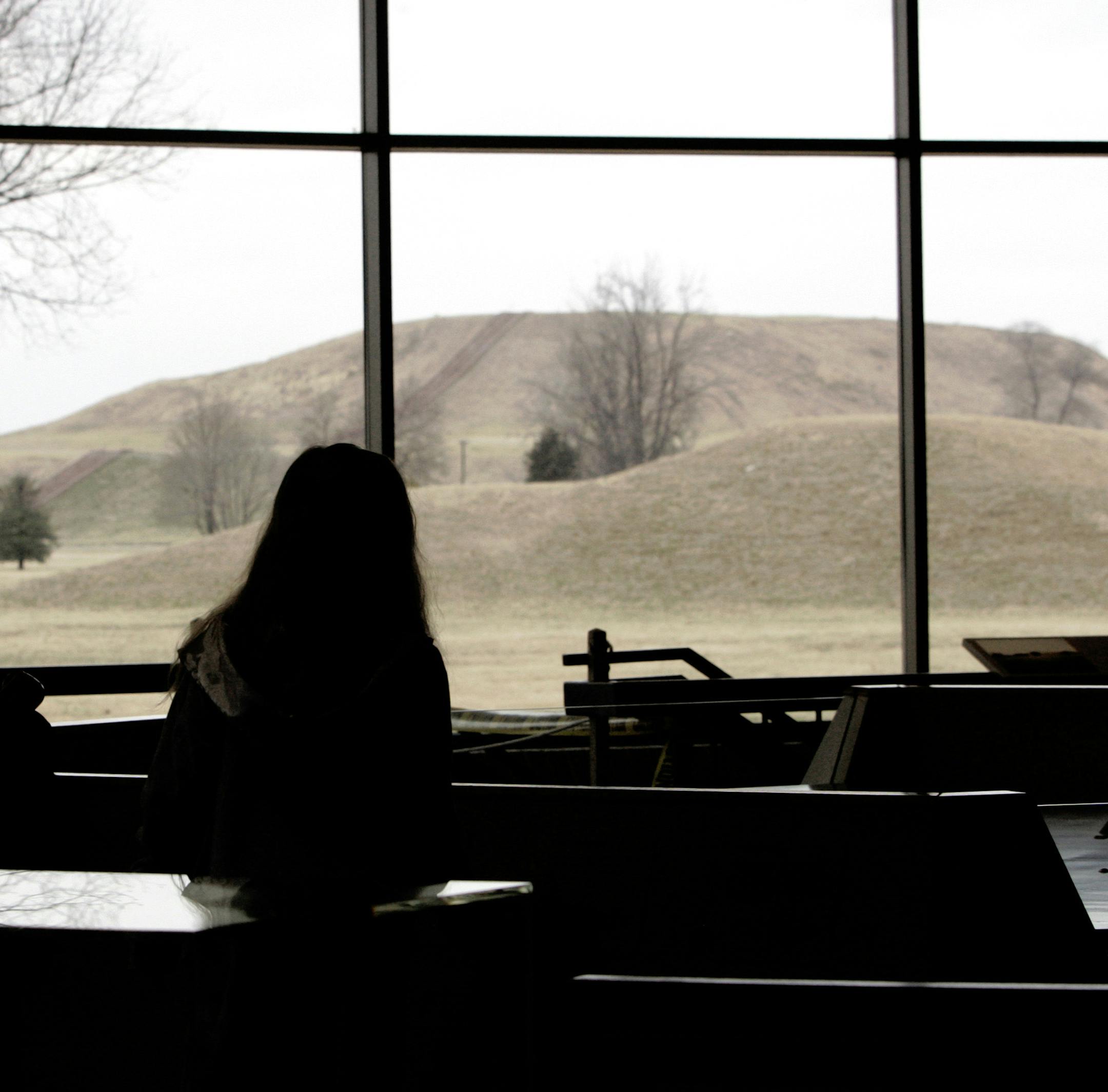 **FILE** Visitors to the Cahokia Mounds State Historic Site and Interpretive Center in Collinsville, Ill., look through the window at Monks Mound, considered the largest prehistoric earthen construction in the New World in this Feb. 16, 2006, file photo. On Thursday, Dec. 6, 2007, the Illinois Pollution Control Board rejected an appeal filed months ago by the Illinois Sierra Club and the American Bottom Conservancy to block a Metro East landfill's expansion near the historic site. (AP Photo/Jame