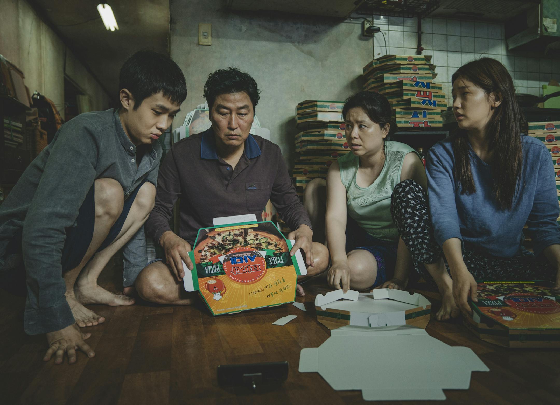 This image released by Neon shows Woo-sik Choi, from left, Kang-ho Song, Hye-jin Jang and So-dam Park in a scene from "Parasite." (Neon via AP)