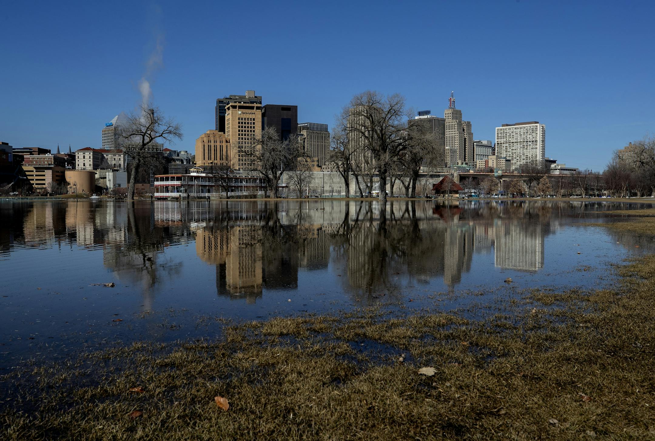 Downtown St. Paul reflected in the water flooding Harriet Island Regional Park on Monday afternoon.