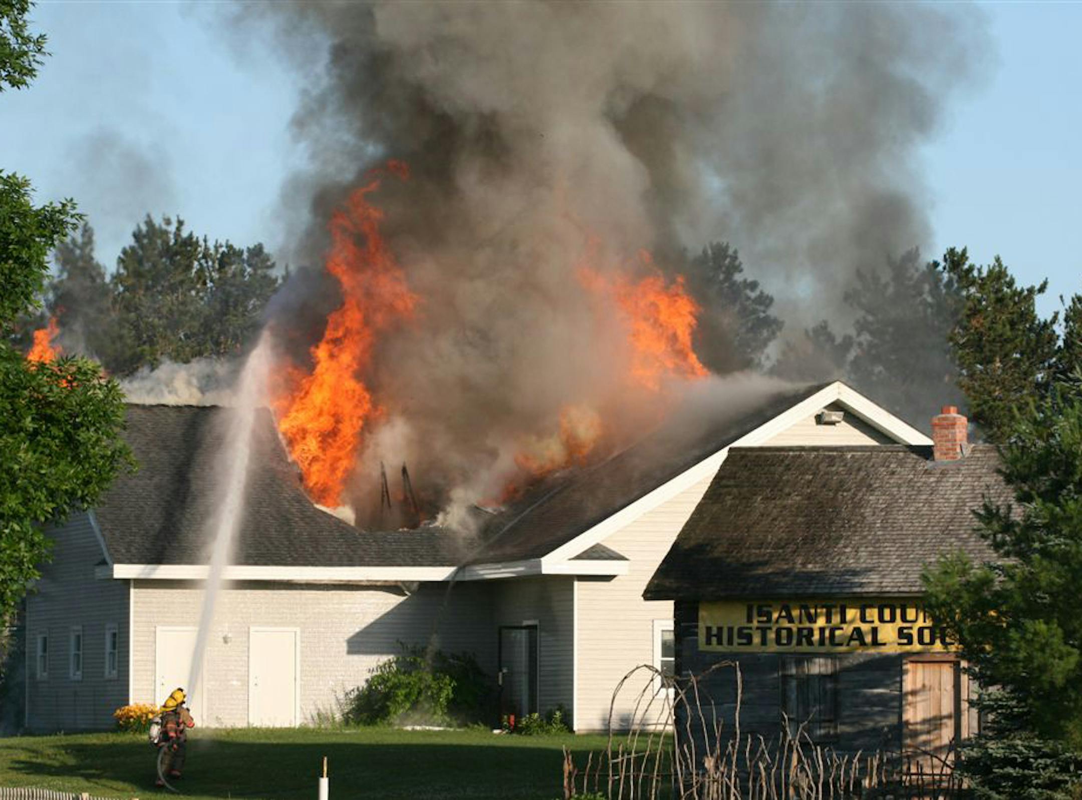 The Isanti county Historical Society building is consumed by flames Friday, July 8, 2011. An arson fire that destroyed the Isanti County Historical Society building in Cambridge did potentially irreparable damage to a treasure trove -- church records, school yearbooks, family histories, wartime scrapbooks, cemetery records, plat maps from the 1800s, military uniforms, even sewing machines. ] Photo special to the Star Tribune - Andy Fiedler