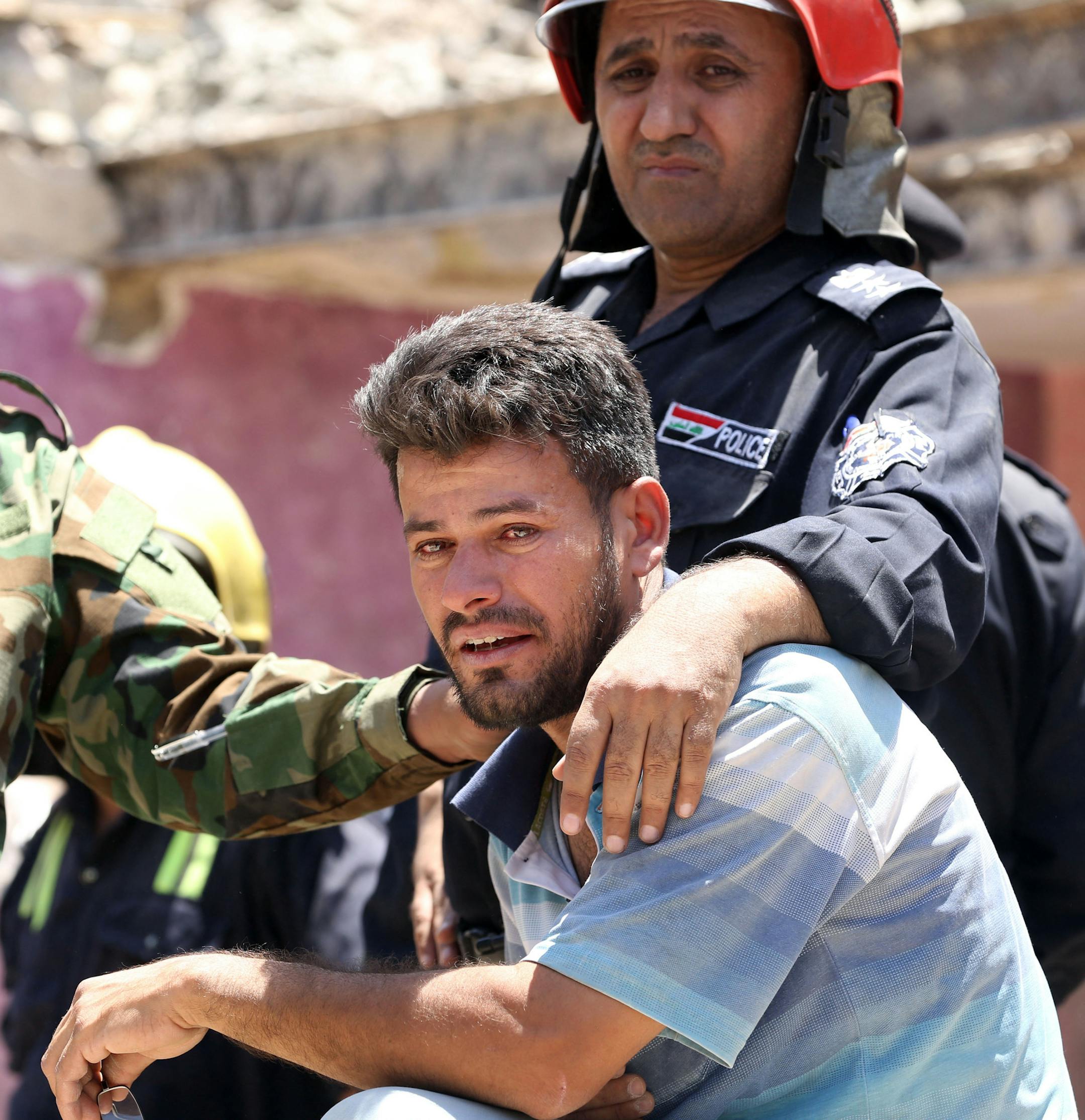 An Iraqi man grieves after losing several members of his family after a bombing in the eastern neighborhood of New Baghdad. Iraq, Monday, July 6, 2015. At least a dozen civilians were killed on Monday when a Russian-made fighter jet accidentally dropped a bomb over a Baghdad neighborhood, officials said. (AP Photo/Hadi Mizban)