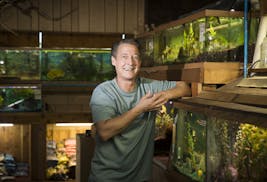 Kevin McMenamy started his tropical fish store nearly 40 years ago in a spirit of whimsy. So, he plans on going out of business the same way. He posed