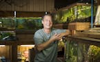 Kevin McMenamy started his tropical fish store nearly 40 years ago in a spirit of whimsy. So, he plans on going out of business the same way. He posed