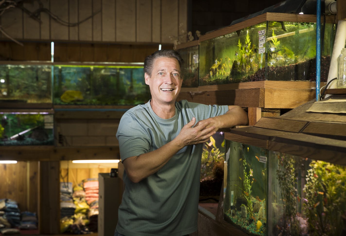 Kevin McMenamy started his tropical fish store nearly 40 years ago in a spirit of whimsy. So, he plans on going out of business the same way. He posed for a picture in his store Aquatropics Aquarium Center on August 8, 2017 in Crystal, Minn. ] RENEE JONES SCHNEIDER &#xef; renee.jones@startribune.com