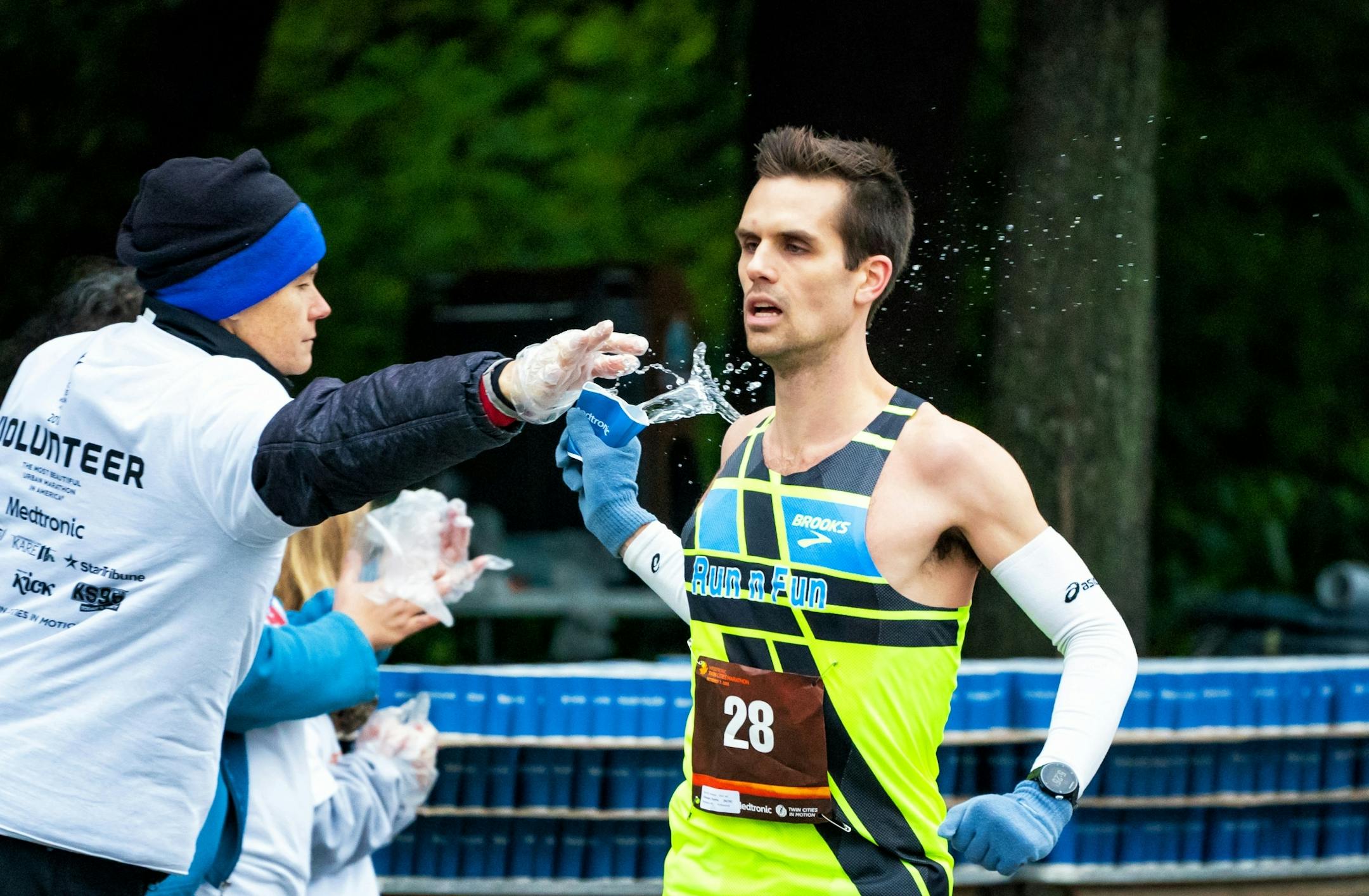 Timothy Lillehaugen grabbed a cup of water along Cedar Ave near mile 11 during the Twin Cities Marathon. Lillehaugen, from Minneapolis came in 9th.