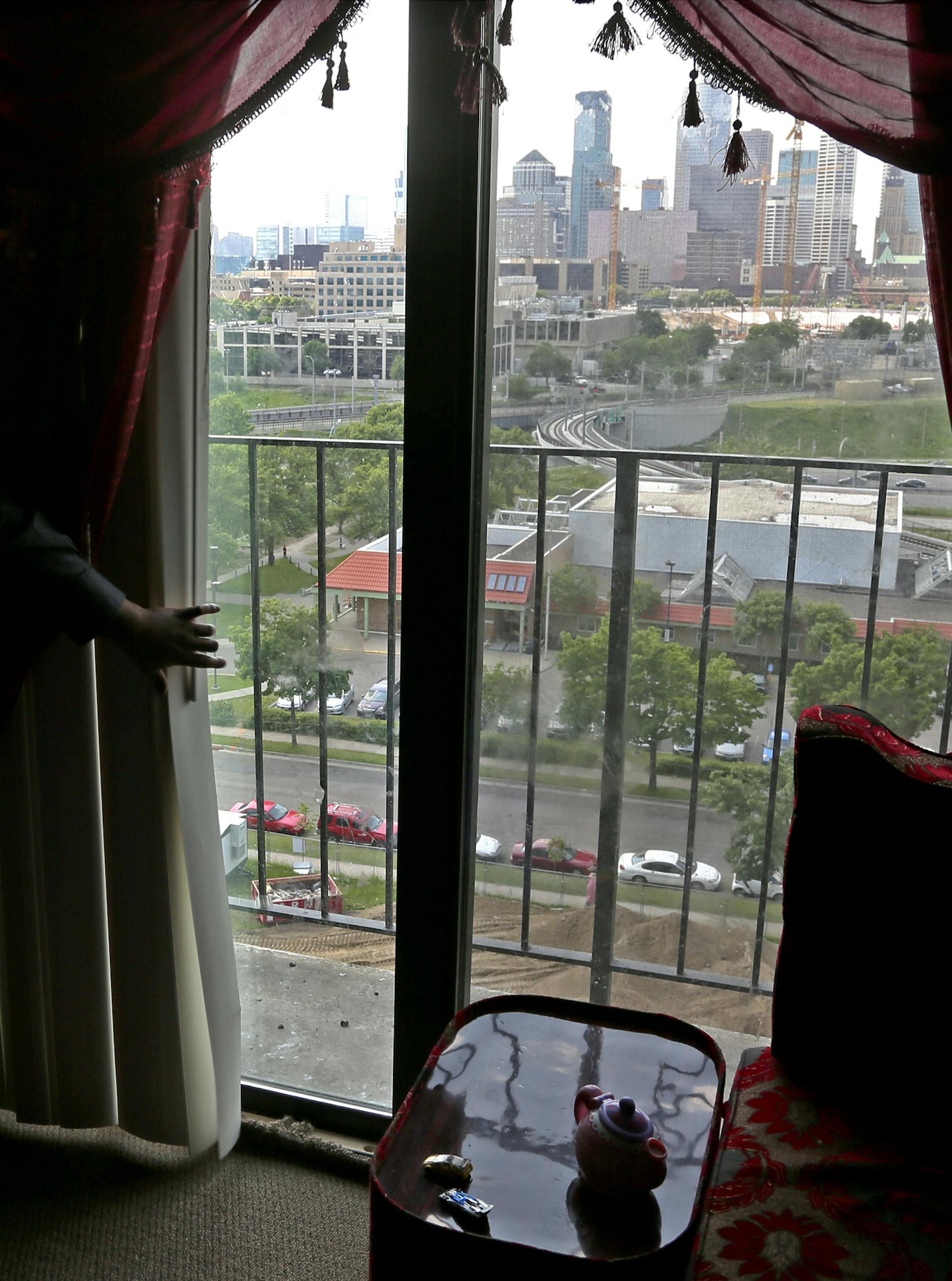 A miraculous recovery: One reminder of Musa Dayib’s fall, top left: a pink scar the size of a quarter on the back of his head. His family still lives in the 11th-floor Riverside Plaza apartment from which he fell, above, but plans to move once a lower unit becomes available. The property owner has locked the balcony door at the family’s request.