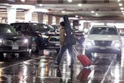 A traveler navigates the rideshare area in Terminal 1 at Minneapolis-St. Paul International Airport on Friday.