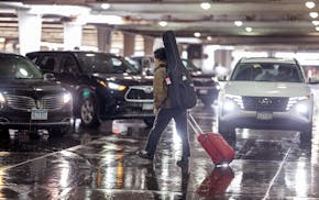 Travelers navigate the rideshare area in Terminal 1 at the Minneapolis-St. Paul International Airport on March 22.