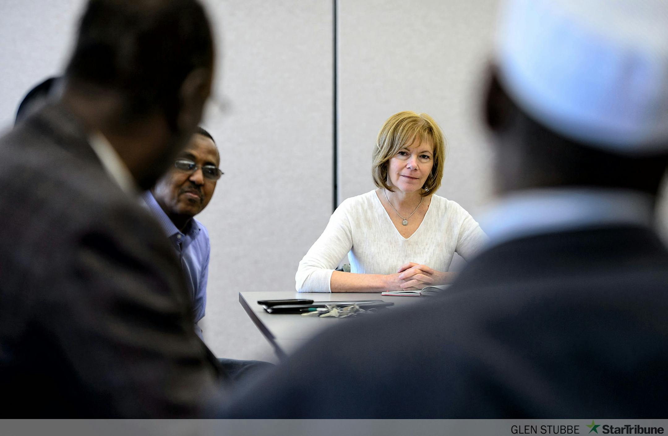 With the help of interpreter Abdirizak Mahboub, left, a Somali community organizer. Lt. Governor candidate and Mark Dayton's running mate Tina Smith met with Somali Leaders in a conference room in the Willmar library.    ]   GLEN STUBBE * gstubbe@startribune.com   Saturday, April 12, 2014