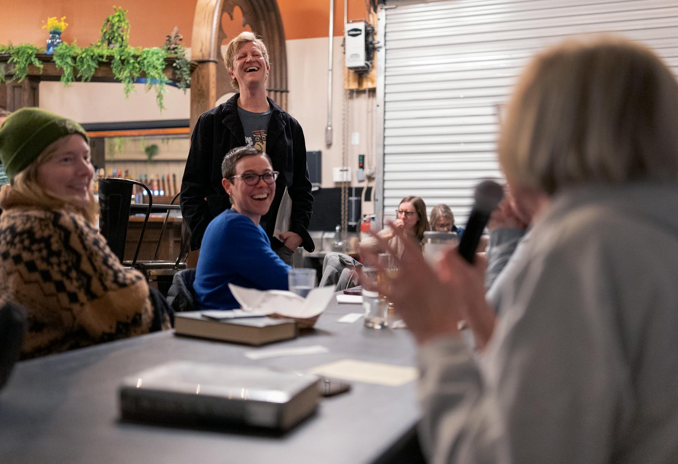 photo of a man leading a book club discussion group