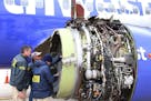 FILE- In this April 17, 2018, file photo National Transportation Safety Board investigators examine damage to the engine of the Southwest Airlines pla