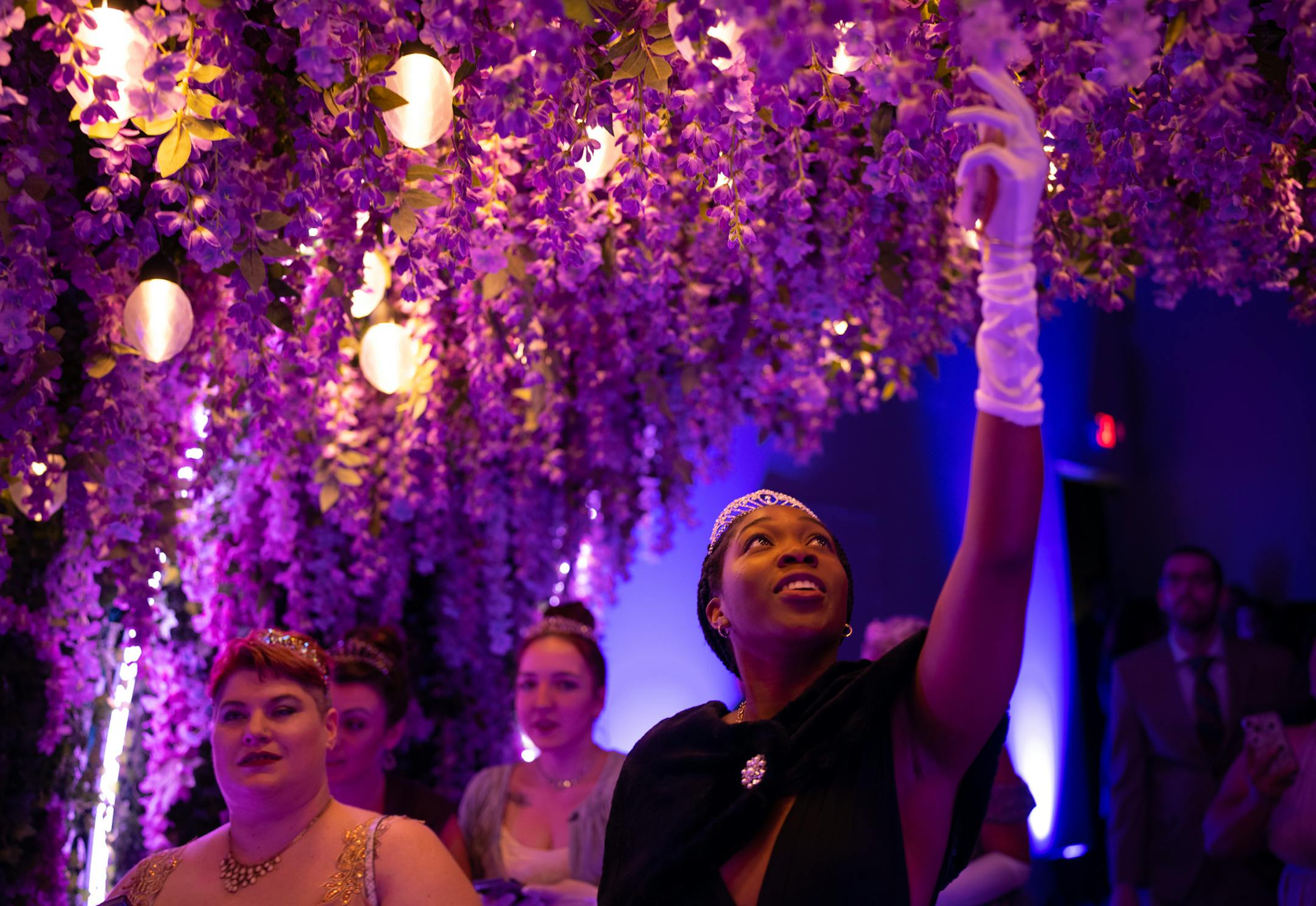 Guests walked through a tunnel of flowers as they made their way to the ballroom on opening night of The Queen's Ball: A Bridgerton Experience.
