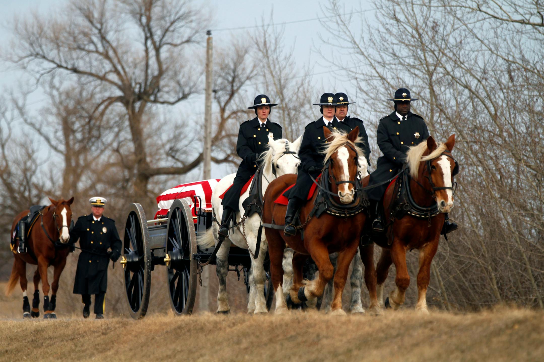 The body of slain police officer Tom Decker arrives at St. Nicholas Catholic Cemetery.
